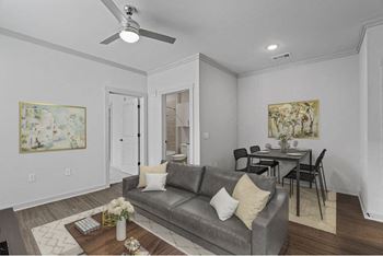 A living room with a grey couch and a coffee table.