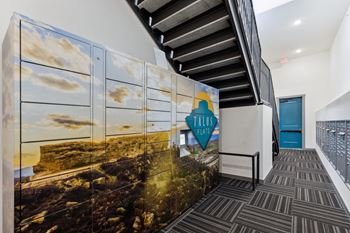 A hallway with a mural of a beach scene and the words "FALLS FLATS" on it.