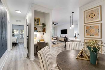 A modern living room with a wooden floor and a striped sofa.