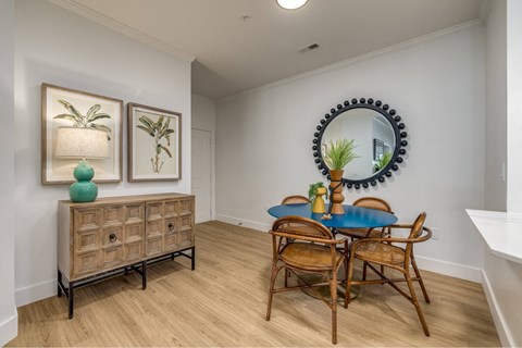 A dining room with a blue table and chairs.
