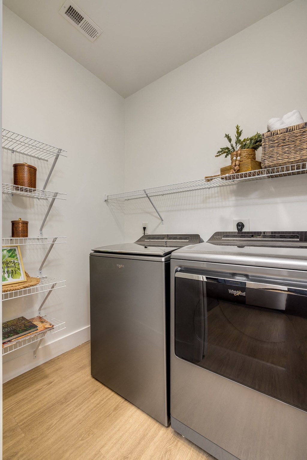 A kitchen with a stainless steel oven and a black dishwasher.
