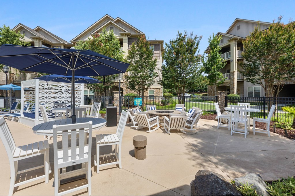 A sunny day at a residential outdoor area with a table and chairs set up.