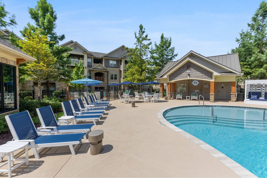luxury apartments in Charlotte NC with In-Unit Washer and Dryer - The Banks at Rivergate - A large outdoor swimming pool surrounded by lounge chairs and umbrellas.