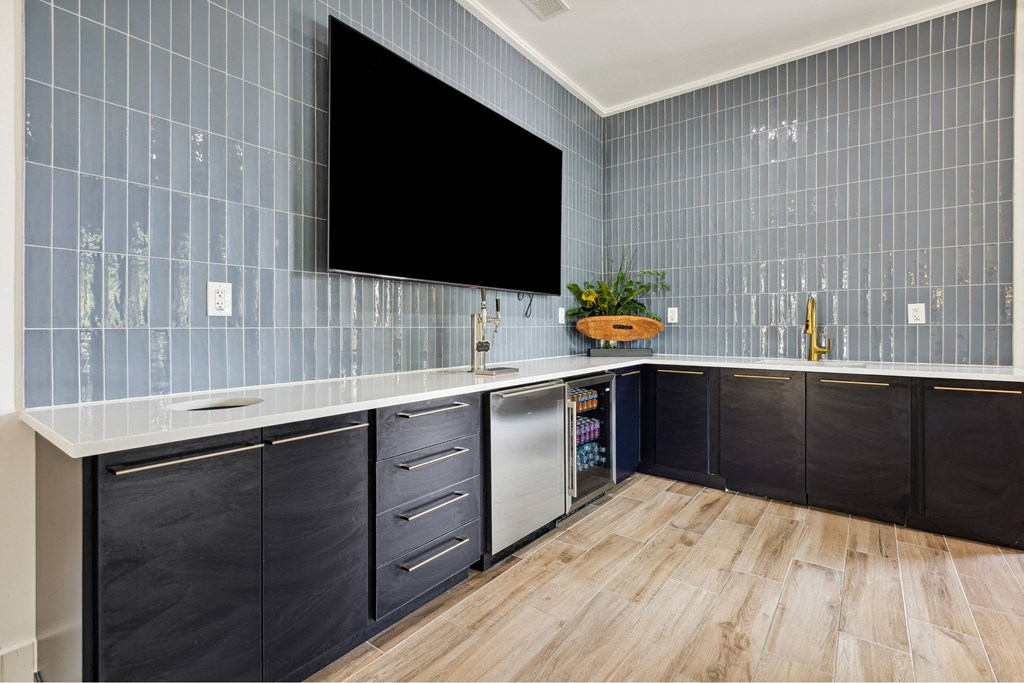 A kitchen with a black screen on the wall.