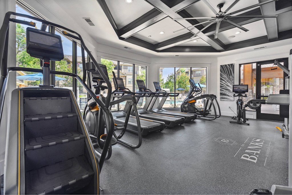 A gym with treadmills, elliptical machines, and a stair climber.