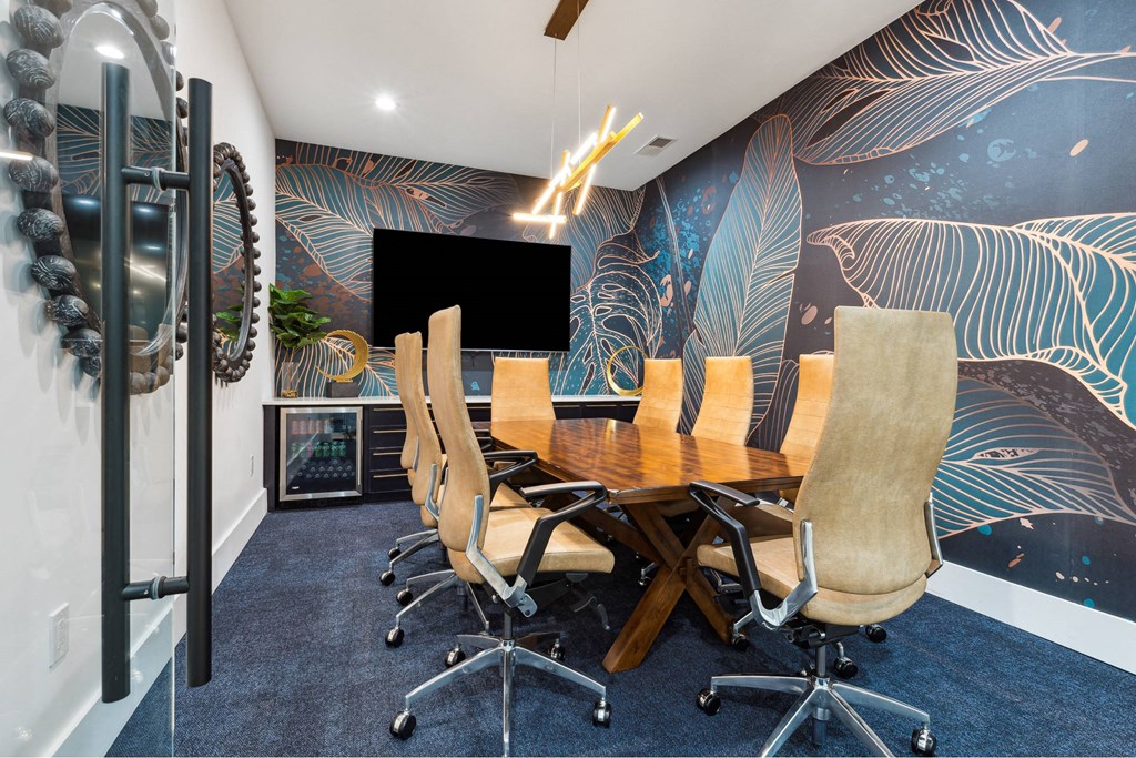 A conference room with a long table and chairs.