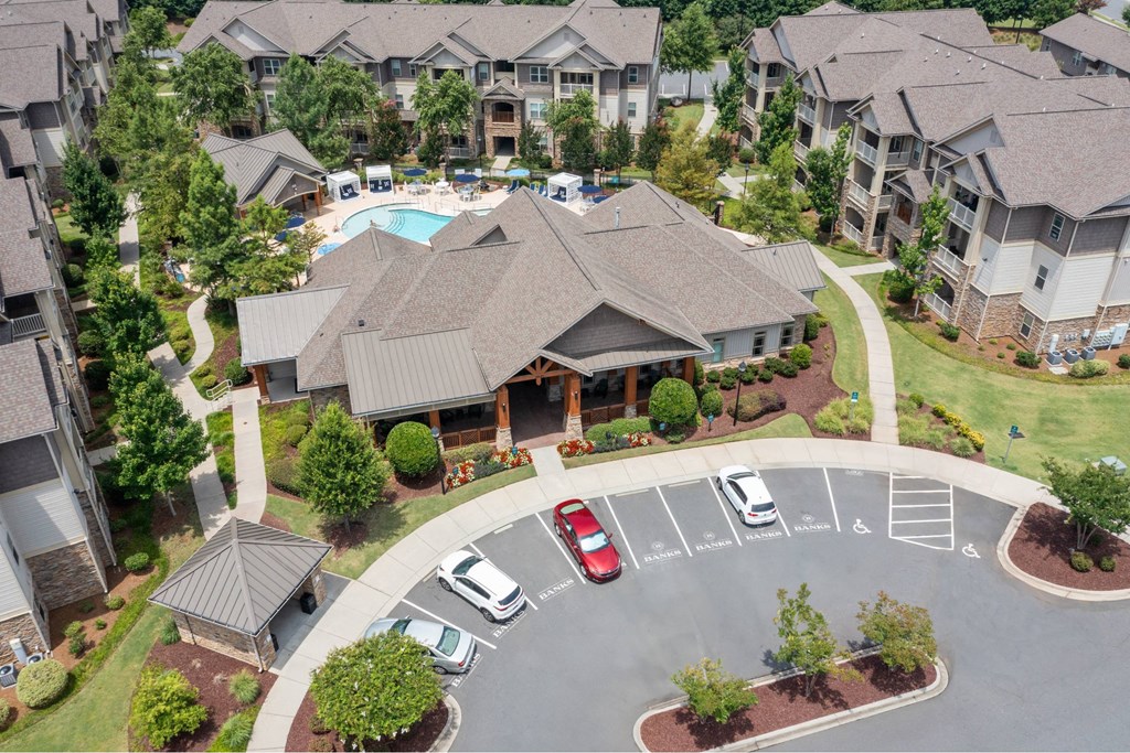 A large building with a pool in the middle of a parking lot.