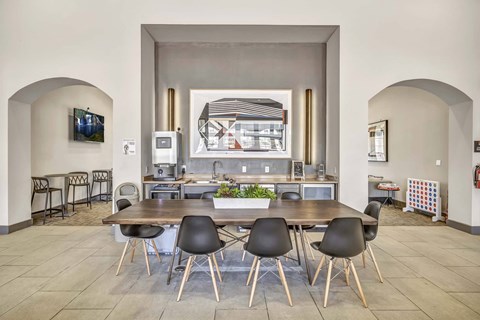 A modern kitchen with a dining table and chairs.