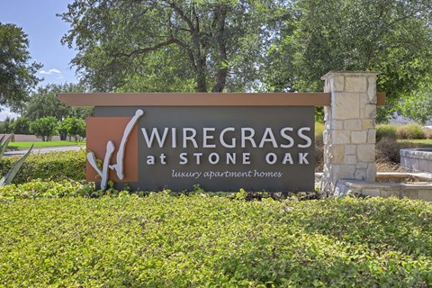 A sign for Wiregrass at Stone Oak, a luxury apartment homes.