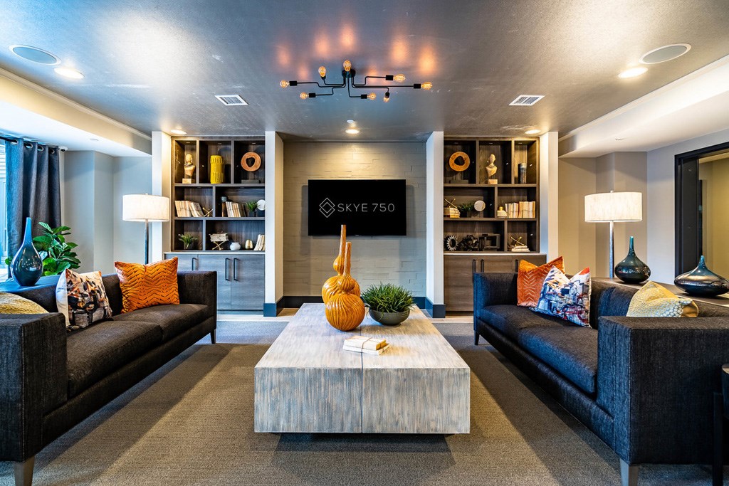 A modern living room with a wooden coffee table in the center.