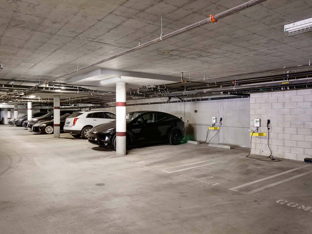 A black car is parked in a parking garage.