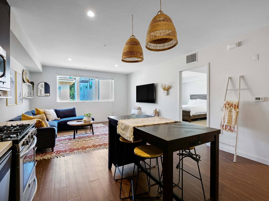 A modern kitchen with a black countertop and a stove top oven.