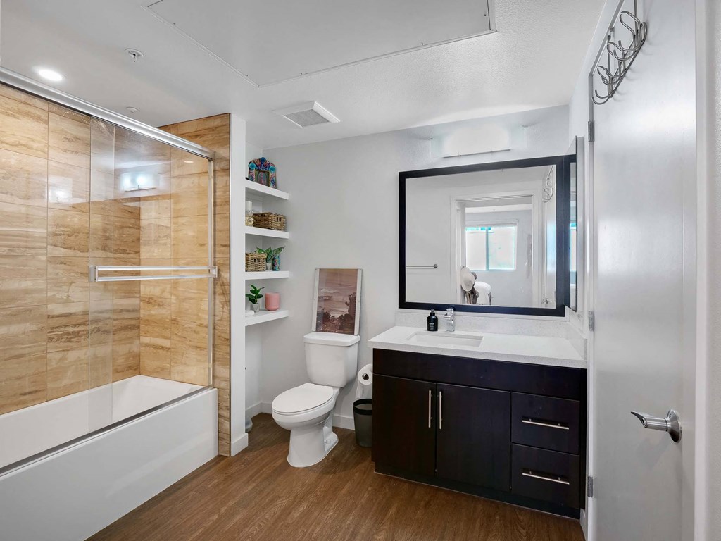 A bathroom with a wooden wall and a white toilet.