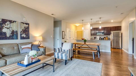 A modern living room with a wooden coffee table and striped armchair.