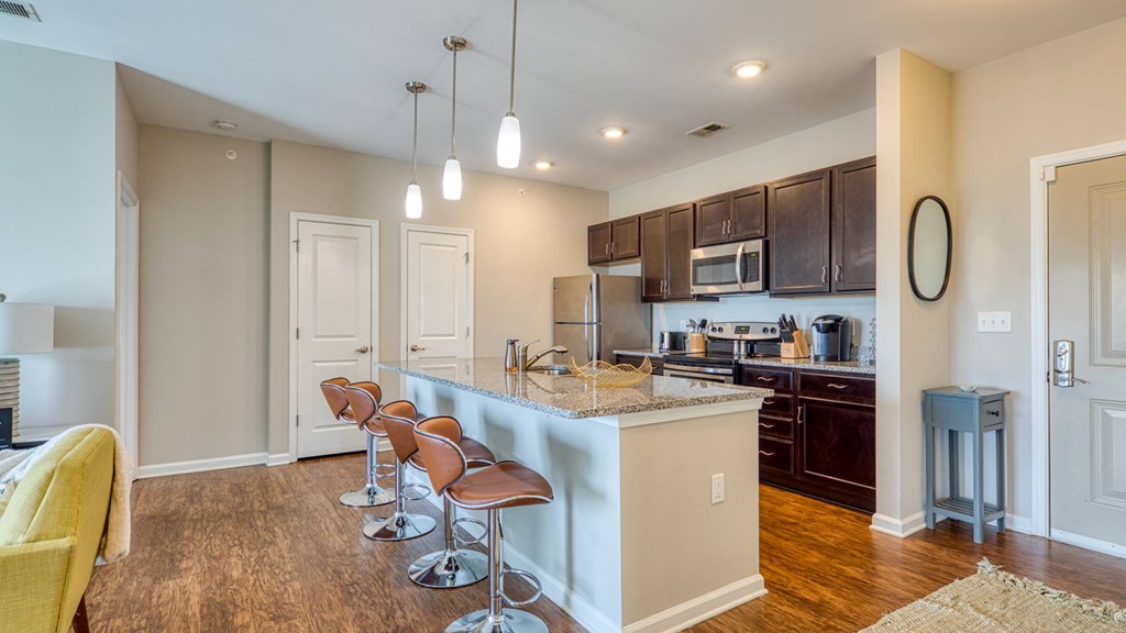 A kitchen with brown cabinets and a white island.