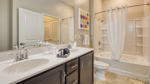 A bathroom with a white sink and a white toilet.