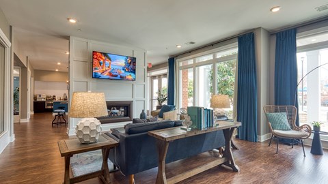 A living room with a television, a sofa, and a coffee table.