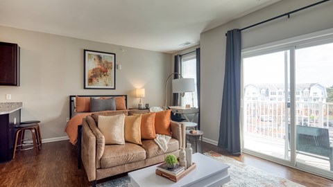 A living room with a couch, a chair, a coffee table, and a fireplace.