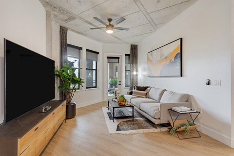 A living room with a flat screen TV and a couch.