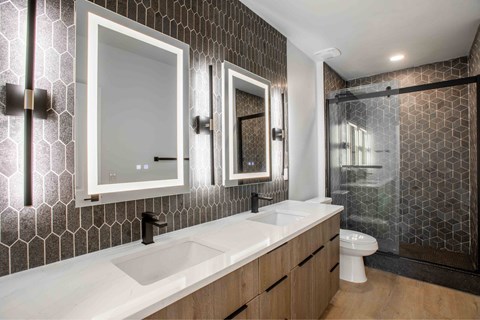 A modern bathroom with a white sink and a toilet.