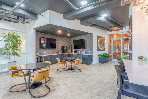 A modern dining area with a glass table and chairs.