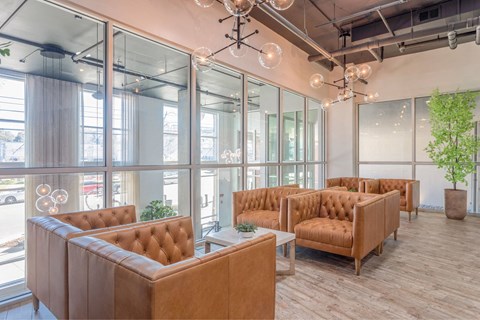 A room with brown chairs and a wooden floor.