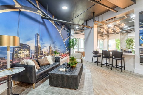 A modern living room with a large cityscape mural on the wall.