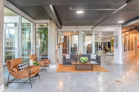 A modern living room with a large window and a grey floor.