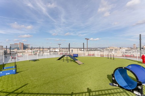 A playground with a blue slide and a red fire hydrant.