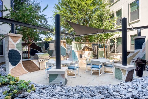 A patio with a table and chairs under a canopy.
