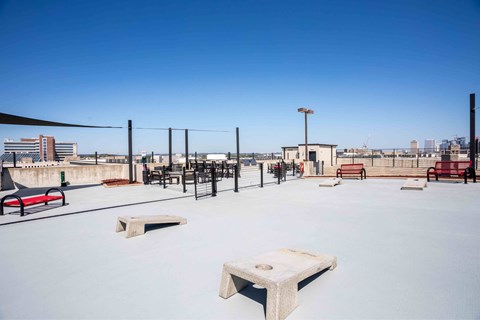 A snow-covered park with benches and a fence.