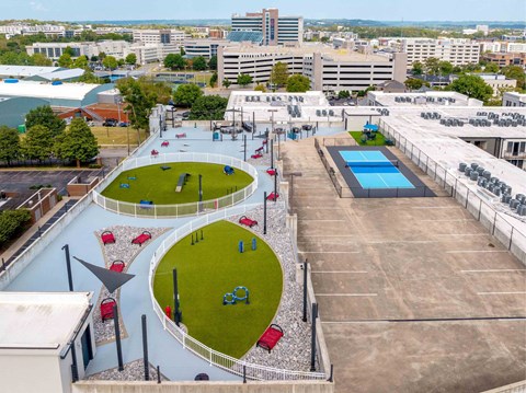 A playground with a blue pool and a slide.