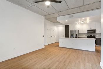 A kitchen area with a refrigerator, microwave, and oven.
