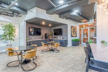 A modern dining area with a long table and chairs.