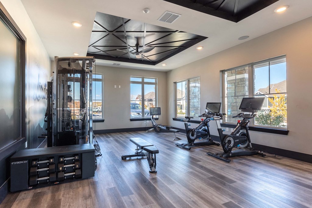 A spacious home gym with a variety of exercise equipment.