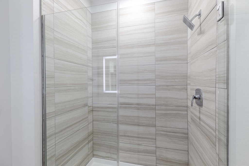 A modern bathroom with a glass shower stall.