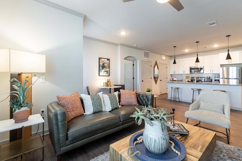A living room with a grey couch and a wooden coffee table.