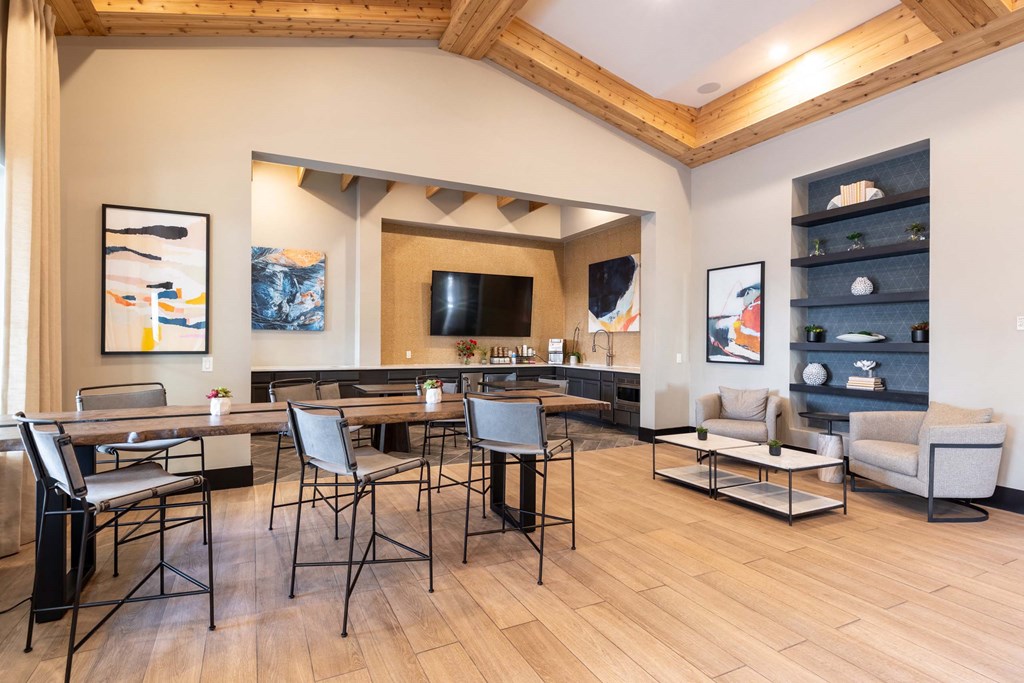 A modern living room with a wooden floor and a large dining table.