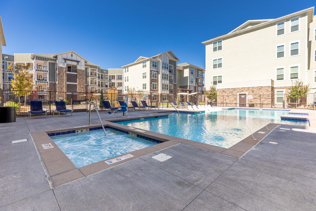 A swimming pool surrounded by apartment buildings.