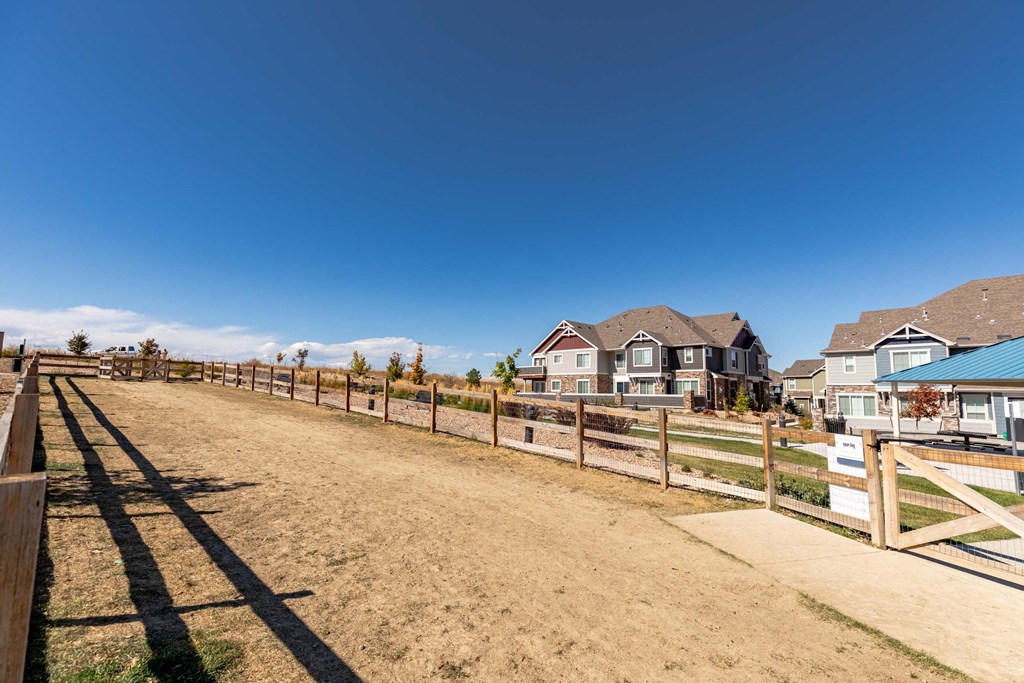 A row of houses with a fence in front of them.