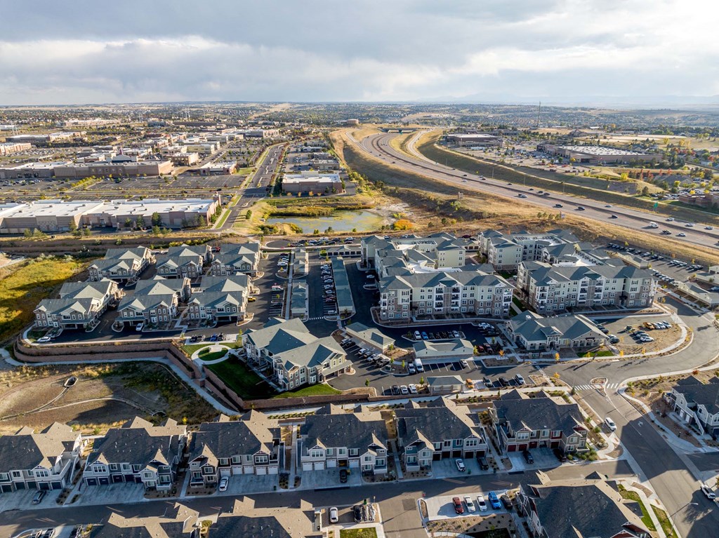 A bird's eye view of a residential area with houses and a road.