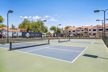 A tennis court with a banner that says "HIDEAWAY" on it.