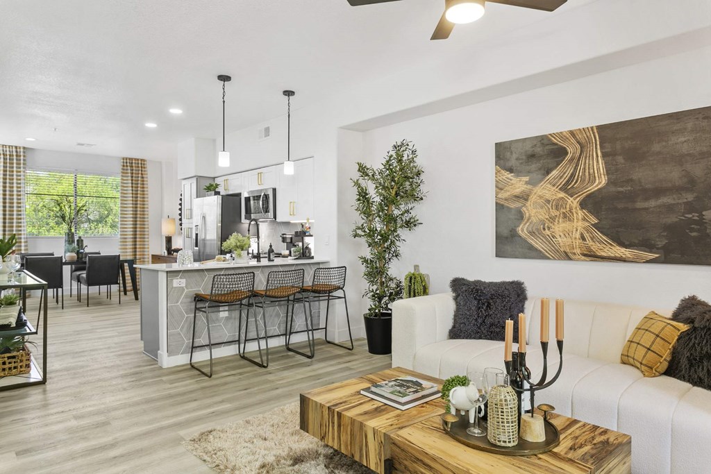 A modern living room with a white couch and a wooden coffee table.