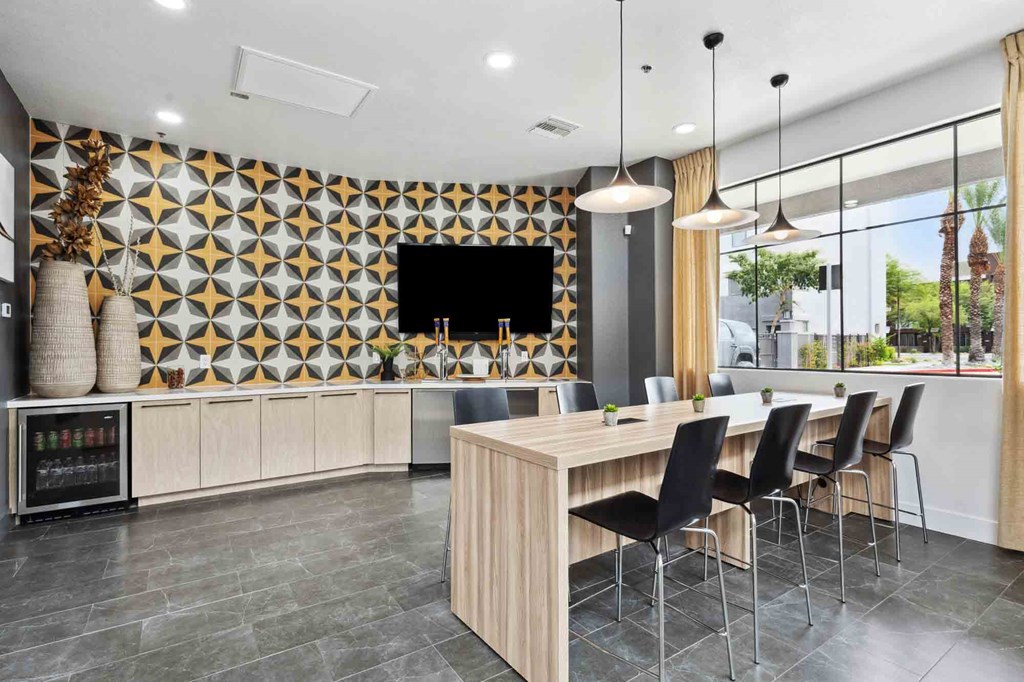 A modern kitchen with a wooden table and chairs.