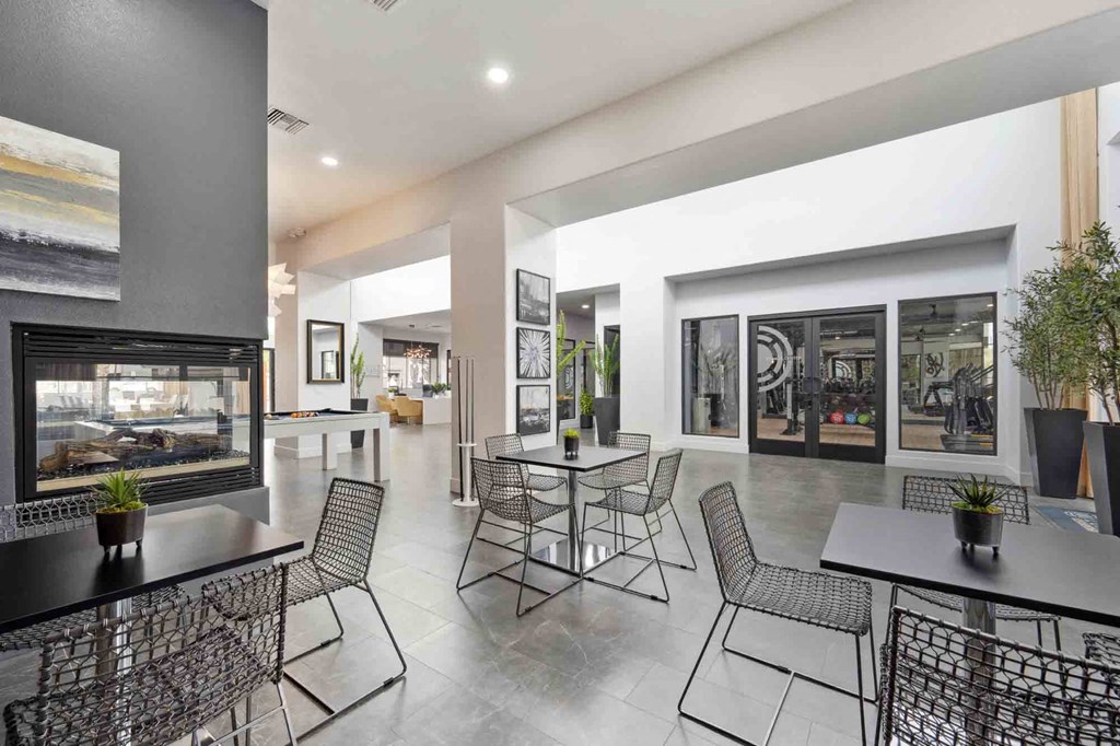 A modern dining area with a glass wall and a view of the outside.