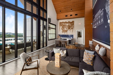 A living room with a couch, a chair, and a table.
