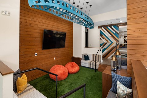 A room with a wooden wall and a TV mounted on it.