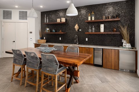 A kitchen with a wooden table and chairs.