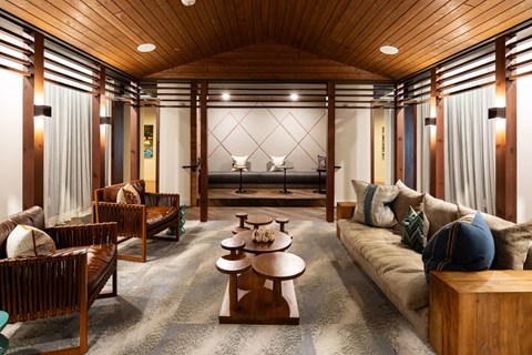 A living room with wooden furniture and a large window.