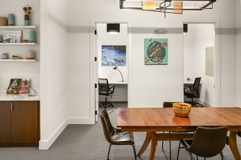 A room with a table and chairs in it.